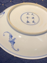 A Chinese verte biscuit figure, a green 'lotus' jar and a figurative blue and white plate, Kangxi and later